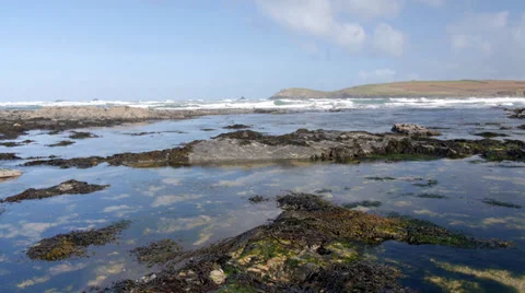 Tide coming in over rock pools on beach, Constantine Bay, Cornwall, UK Stock Footage 37165379