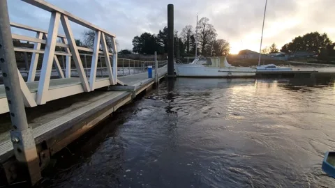 Tide flowing under Kirkcudbright pier on the River Dee estuary on a winter da Stock Footage 147600591