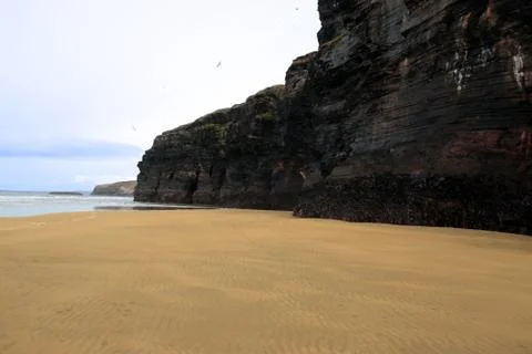 Tide in front of cliff Stock Photos