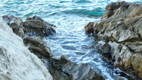 Tide lapping against the rocks Stock Footage 148790993