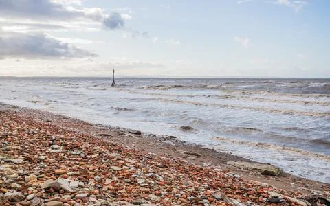 Tide marker behind the red bricks on Crosby beach Stock Photos