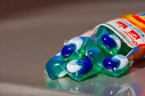 Tide pods with laundry detergent Stock Photos