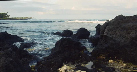 Tide pool with volcanic rock and ocean waves in Hawaii Stock Footage 330754680