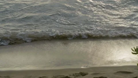 Tide receding from shore at sunset Stock Footage 160809632