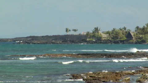 Tide rolls into island beach onto rocks in ocean Stock Footage 125341069