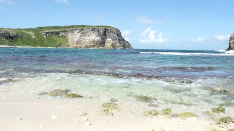 Tide with waves and cliffs in the distance in the coastal area of Guadeloupe Stock Footage 247513004