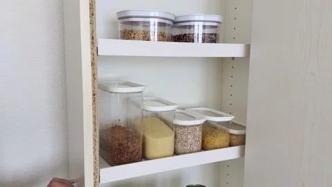 Tidy Kitchen Cupboard with Grain Containers, Space Saving Pantry Storage Stock Footage 346067477