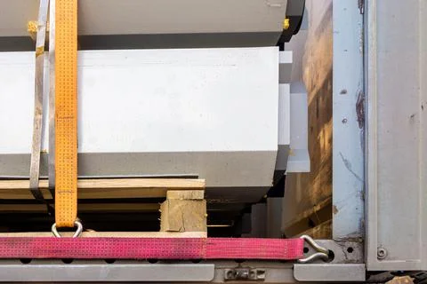 A tie down strapdown ratchet strap is a fastener used to hold down cargo or e Stock Photos