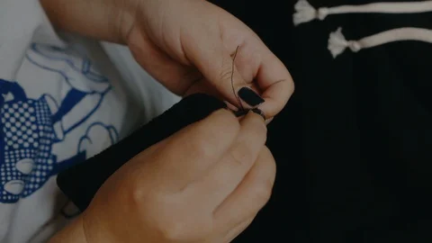 Tie a knot of thread Stock Footage 129606458