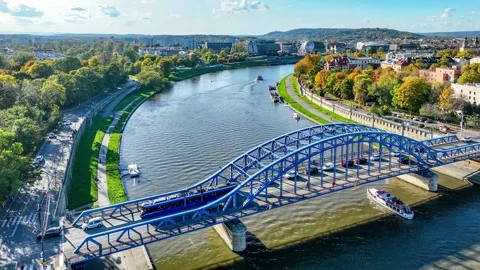 Tied-arc bridge, tram, ship and cars  in Krakow, Poland. Aerial video Stock Footage 258152665