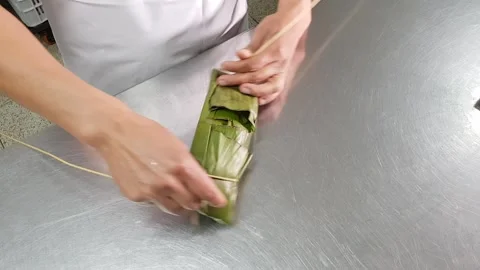 Tied with a typical Peruvian tamale made from corn, pork and olives. Stock Footage 142411250