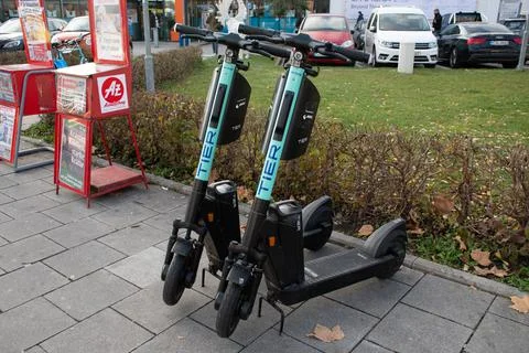 TIER Shared E-Scooters Parked on Sidewalk in Munich, Germany Stock Photos