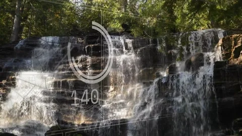 Tiered falls flowing in forest, HUD overlay fading in, numbers rising then Vídeo Stock 330393718