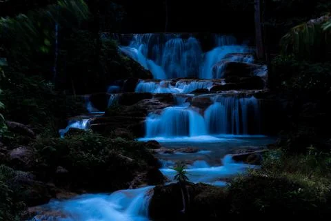 Tiered Waterfall Cascading Through Dark Tropical Jungle At Night Ground Lev.. 스톡 사진