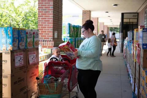 Tiffany Hardeman shops during a case lot sale at the Commissary with her d... Stock Photos