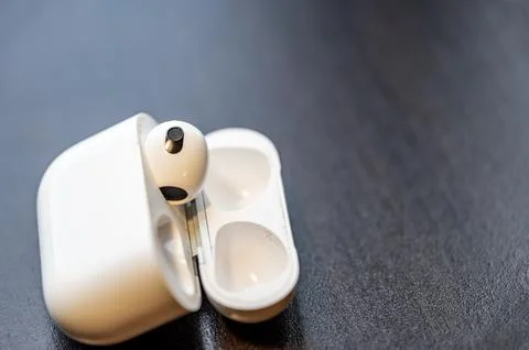 Tiffin, Iowa - 6.2022 - Missing Apple AirPod with a charging case next to it. Stock Photos