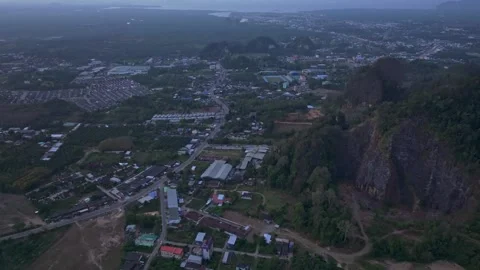 Tiger Cave Temple glows atop lush mountain scenery, Thailand Stock Footage 309800534