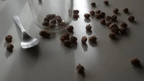 Tiger Nuts Poured Into Glass Jar with Spoon on Kitchen Table in Natural Light Stock Footage 336477644