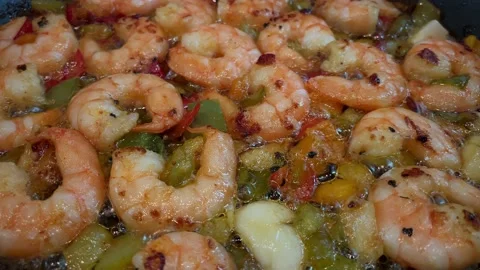 Tiger prawns fried in a frying pan with vegetables and garlic close-up Stock Footage 221962753