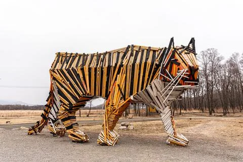 Tiger statue in the forest, copy of specification. Tiger made of wood Stock Photos