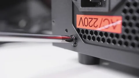 Tight the bolt using crosshead screwdriver, assembling computer power supply Stock Footage 234049453