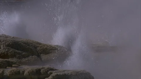 Tight close-up of powerful rush of water being ejected from Yellowstone geyser. Video stock 86756502