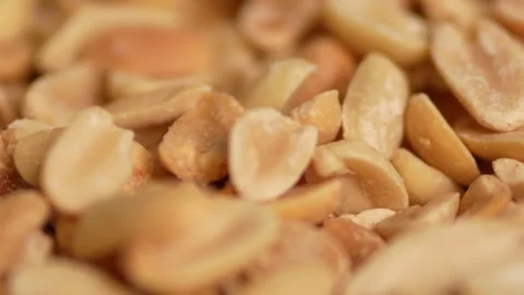 A tight macro close-up of roasted peanuts Stock Footage 328713417