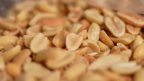 A tight macro close-up of roasted peanuts Stock Footage 328713427