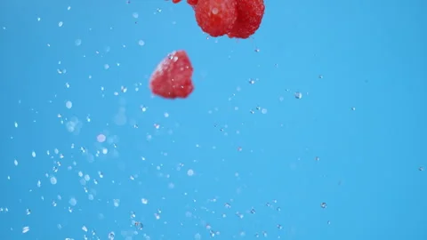 A tight pack of raspberries flying in air with an explosion of water Stock Footage 281142251