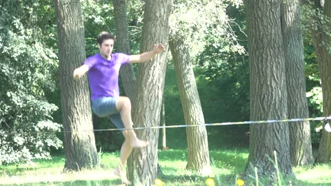 Tight Rope Walker balancing in the park Stock Footage 158945482