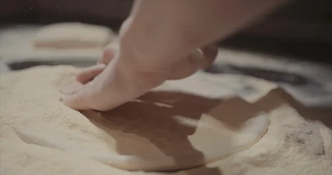 Tight shot of hands working and stretching pizza dough Stock Footage 105298828