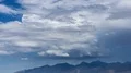 tight shot large thunderhead buildup over mountain range and rain time lapse HD Footage