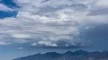tight shot  large thunderhead buildup over mountain range and rain time lapse HD 影片