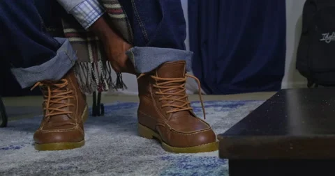Tight shot of man tying the laces of his autumn fall boots left Stock Footage 204052143