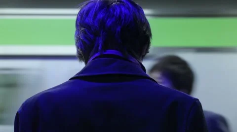 TIGHT SHOT OF A MAN WAITING FOR A TRAIN AT TOKYO TRAIN STATION UNDER BLUE LIGHT Stock-Footage 59921972