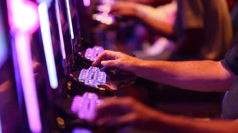 TIGHT SHOT OF PEOPLE'S HANDS PLAYING SLOT MACHINES AT CASINO Stock Footage 59923247