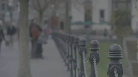 Tight shot on railing focus pull to walking tourists Stock Footage 127044018