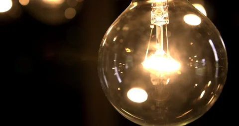 Tight shot of a single edison light bulb Stock Footage 98357751