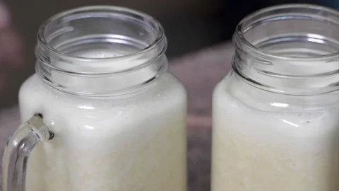 A Tight shot of straws being put in jar with smoothie Stock Footage 155456698