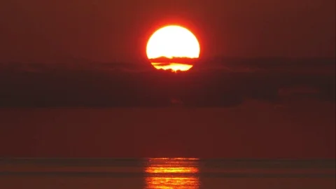 Tight shot of Sun Setting  Behind Clouds over Caribbean Sea Stock Footage 82878775