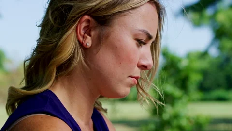 Tight shot of a woman looking down at a computer while working in an outdoor Stock Footage 319128331