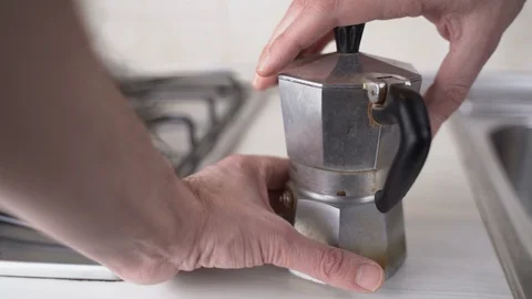 Tighten up a coffee maker Stock Footage 123894388