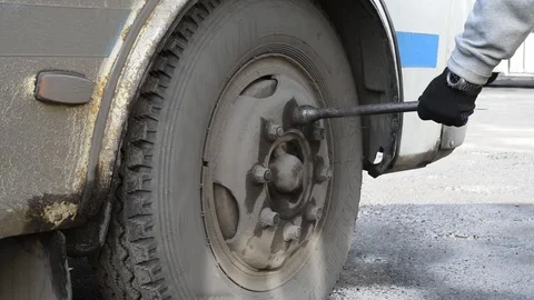Tighten the nuts on the wheel to prevent and test outdoors in natural light Stock Footage 108891471