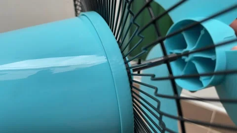 Tighten plastic nut at blue blade fan. Hand fasten bolt rotate installing Stock Footage