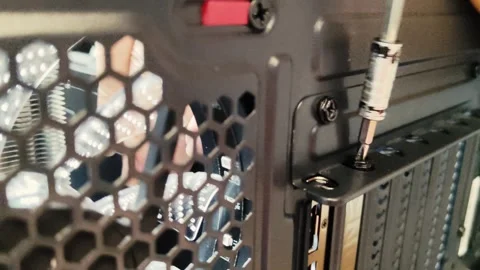 Tighten screw in computer case, tapping with screwdrive, Gamer PC Build assembly Stock Footage 302346807