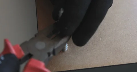 Tighten the screw with pliers Video stock 105695652