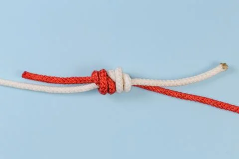 Tightened rope Grapevine knot on a blue background Stock Photos