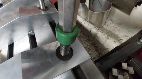 Tightening a green socket head cap screw on a machine fixture table Stock Footage 335826685