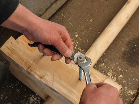 Tightening a nut with a wrench when assembling furniture Stock Photos