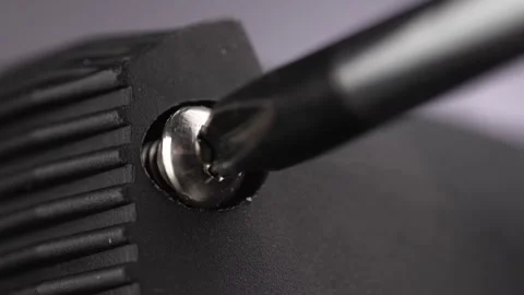 Tightening Screw on Device with Screwdriver. Stock Footage 256237863